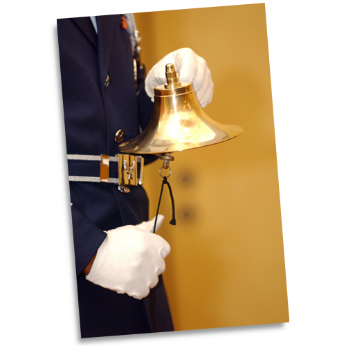 A member of the Offutt Air Force Base Honor Guard rings a bell